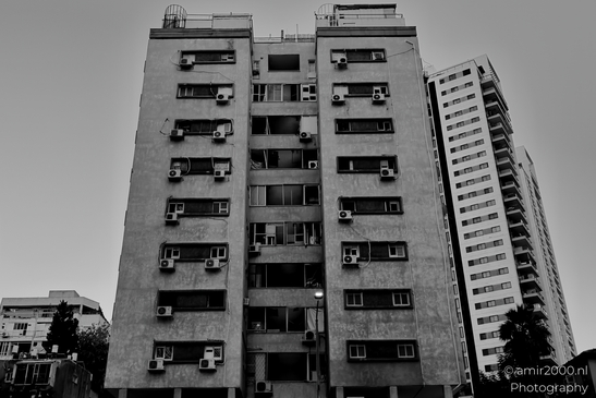 Urban landscapes in Ramat Gan showing visible signs of missile impact, a quiet documentation of structural damage and everyday resilience in times of conflict. Photographed by Amir Darzi. Photography by amir2000.nl, a Dutch photographer.