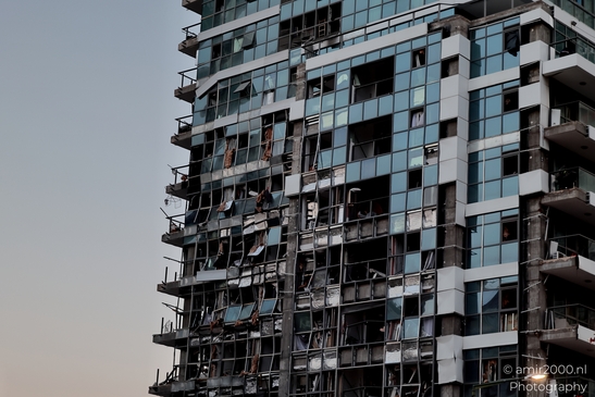 Urban landscapes in Ramat Gan showing visible signs of missile impact, a quiet documentation of structural damage and everyday resilience in times of conflict. Photographed by Amir Darzi. Photography by amir2000.nl, a Dutch photographer.