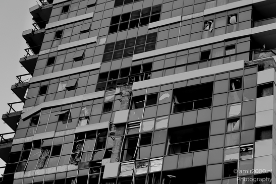 Urban landscapes in Ramat Gan showing visible signs of missile impact, a quiet documentation of structural damage and everyday resilience in times of conflict. Photographed by Amir Darzi. Photography by amir2000.nl, a Dutch photographer.